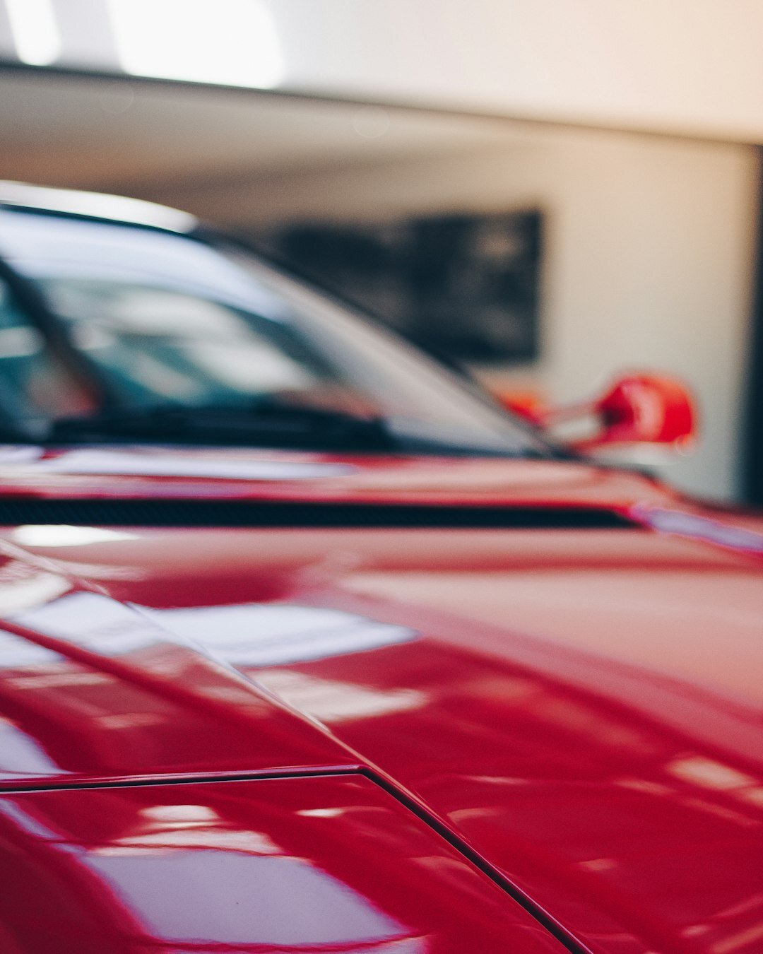 Red sports car parked in a showroom